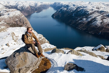 Man Enjoying Scenic Fjord View in Winter