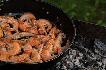 fried king prawns in a frying pan on the fire