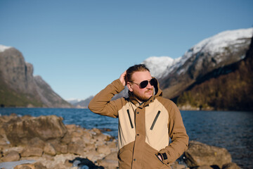 Man in Sunglasses by Mountain Lake