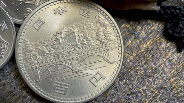 close up view of obverse of 1976 100 yen coin annual commemoration of the emperor of japan.