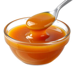 Rich Golden Caramel Sauce Dripping From Spoon Into Glass Bowl.