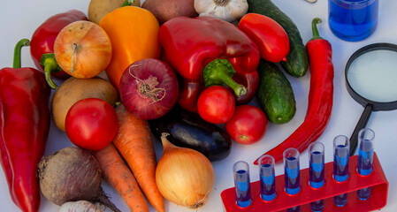 Microscope, test tubes, and fresh vegetables on a lab table for nutritional research