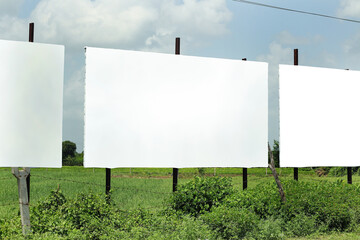 in india. three billboard on city road, outdoor advertising, mockup billing board in front of green tree and Blank white background for branding design large hoarding, Outdoor advertising construction