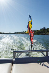 Ukrainian flag waving on a speed boat on the water