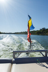 Ukrainian flag waving on a speed boat on the water