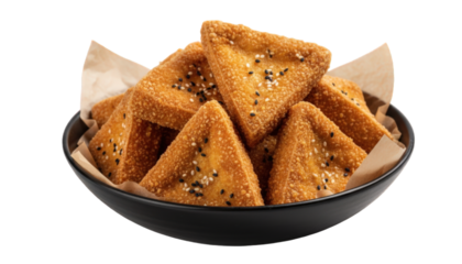 Crispy fried tofu triangles with sesame seeds in a bowl