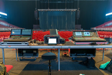 Sound and lighting engineers equipment set up in a concert venue before the show, ready for managing audio and visual effects during the performance