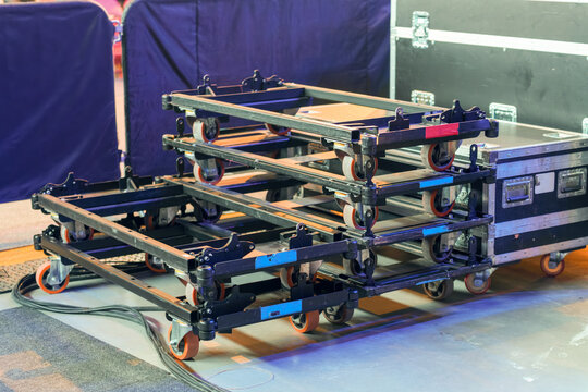 Industrial rolling platforms designed to transport heavy boxes and stage equipment throughout the venue during event setup