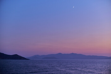 Fototapeta premium Tranquil Seascape at Dusk with Crescent Moon