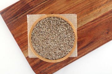 Fresh cumin seeds in wooden bowl ,Close up