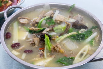 Light chicken and vegetable soup with bok choy, mushroom, tofu and red date in clear broth, comforting and savory meal