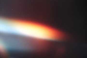 light leak overlay effect with scratch dust and colorful light leaks,retro grain noisy film flare on black background,analog old film burn overlay,abstract distressed background with rays and lens