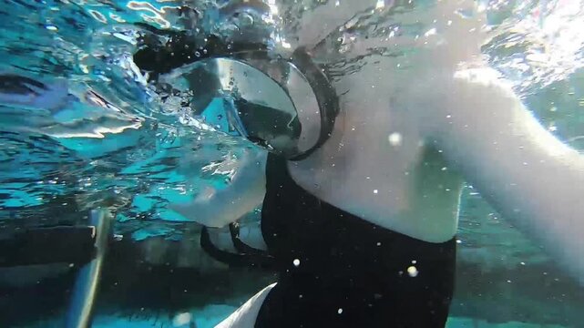 A woman swims with a snorkel for the first time, first training in snorkeling and diving.