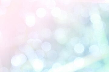 A bokeh background of shining balls in delicate pastel shades of pink and blue.