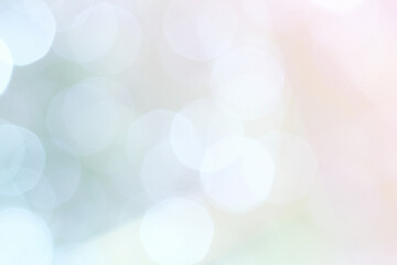 A bokeh background of shining balls in delicate pastel shades of pink and blue.