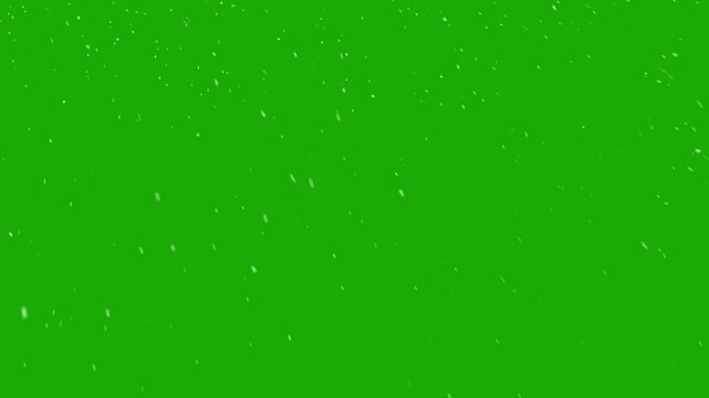 Realistic snow falls across the screen on green screen background, falling snowflake particle effects for christmas holiday celebration, overlay natural winter storm weather isolated backdrop