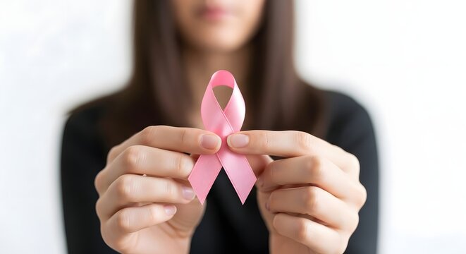 Breast cancer awareness concept with woman holding pink ribbon for health campaign and support initiatives - Powered by Adobe