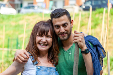 Fototapeta premium Couple working and spending time together in a garden, actively embracing