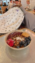 Colourful and delicious acai fruity breakfast bowl with toppings