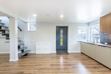 Modern Home Entrace Room Interior with Elegant Stairs and Wooden Floor. Kitchen