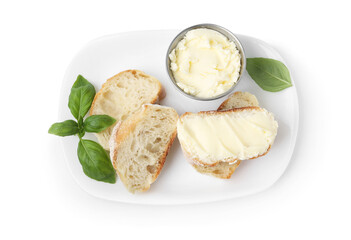 Slices of baguette with butter and basil isolated on white, top view