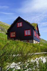 Traditional old houses with grass on the roof and painted black with tar on the Faroe Islands