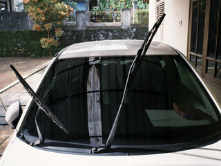 Car's glass wipers lifted for cleaning after exposed to rain