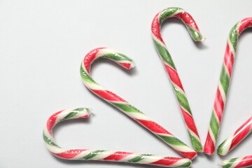 Fototapeta premium Christmas celebration. Candy canes on white background, flat lay