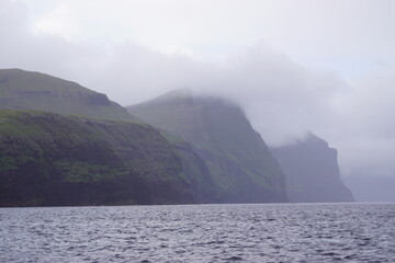 The steep and dramatic coastline around the Vestmanna Cliffs in the Atlantic Ocean off the Faroe Islands © ChrisOvergaard