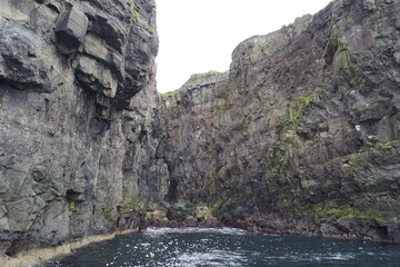 The steep and dramatic coastline around the Vestmanna Cliffs in the Atlantic Ocean off the Faroe Islands © ChrisOvergaard