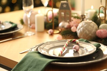 Festive table setting with Christmas decor at home, closeup