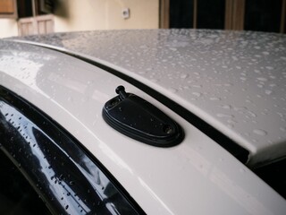 Close up car exterior part exposed with rain water droplets