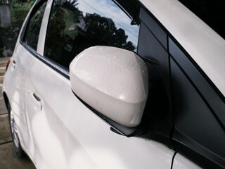 Close up car exterior part exposed with rain water droplets