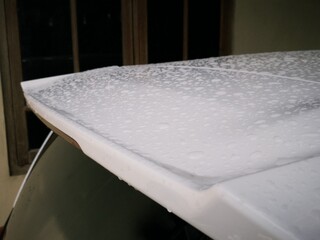 Close up car exterior part exposed with rain water droplets