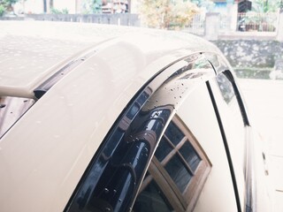 Close up car exterior part exposed with rain water droplets