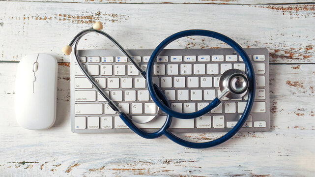 Stethoscope on a Computer Keyboard and Mouse: Telemedicine, Digital Health Records, and Modern Medical Technology - Powered by Adobe