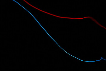Minimalist abstract background with two parallel glowing lines, one blue and one red, on a pure black backdrop. Red and blue laser background