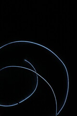 Minimalist abstract background with a single glowing blue neon line on a pure black backdrop. Simple futuristic design element. Blue laser abstract matrix background 