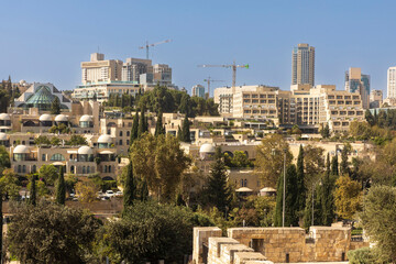 jerusalem, Israel, 2 November 2025, modern architecture showing new residential and commercial complexes with curved roofs and balconies surrounded by greenery, with construction cranes