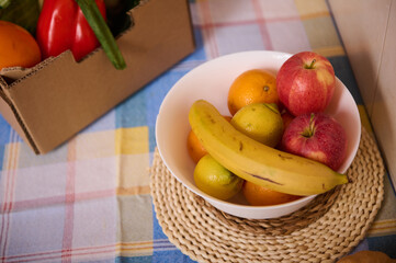Fruit Bowl With Bananas Apples Oranges And Pears On Plaid Tablecloth In Kitchen Scene