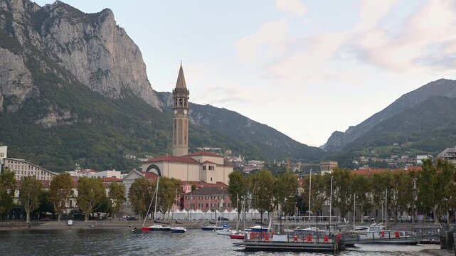 Lake Como and Lecco city, Italy, picturesque city overlooking lake. Characteristic view with the lakeside, the bell tower of the Basilica of San Nicol&ograve;, one of the symbols of the city