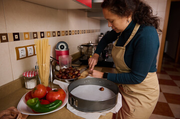 Woman In Apron Preparing Chocolate Treats In Kitchen For Dessert