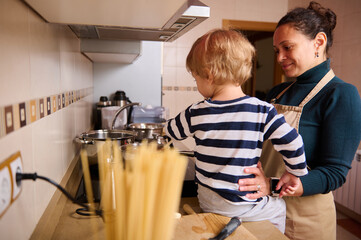 Mother And Child Cooking Together In Kitchen, Happy Home Moment