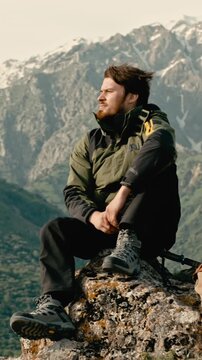 young man traveler enjoying freedom on mountain peak breathtaking view slow motion