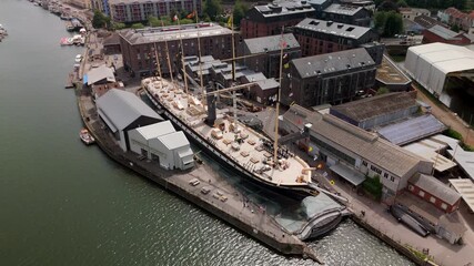 Bristol England: 28th July 2025: Drone view of Brunel's SS Great Britain rests at the dock in Bristol, surrounded by historic buildings along the River Avon