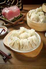 Handmade Mongolian Siu Mai Dumplings with Raw Meat Ingredients in Traditional Bamboo Steamer Setting Hohhot Inner Mongolia