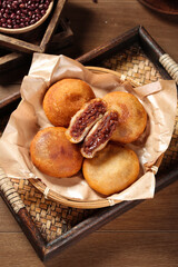 Handmade Deep Fried Red Bean Paste Filled Pastries in Traditional Bamboo Basket