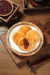 Handmade Asian Bean Paste Pancakes in Bamboo Steamer with Red Adzuki Beans on Wooden Table