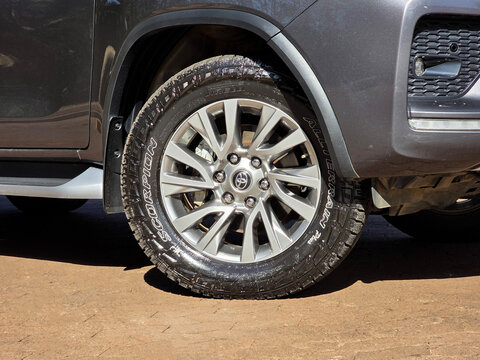 Toyota SW4 all-terrain tire wheel closeup, Gray mid-size SUV detail