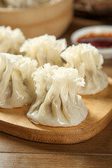 Handmade Beef Shumai Dumplings from Hohhot on Wooden Board with Dipping Sauce - Traditional Chinese Dim Sum